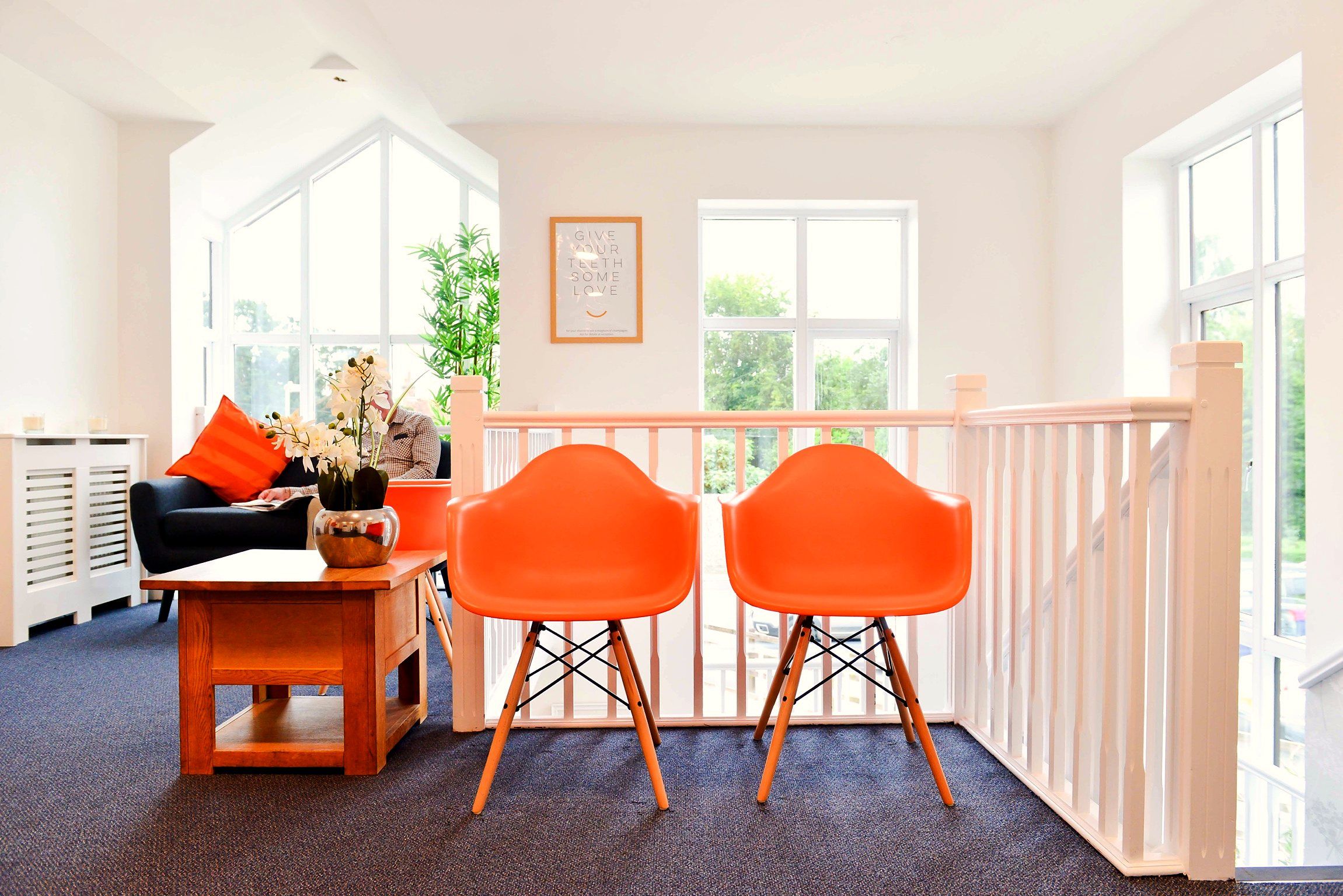 Orange chairs in the bright upstairs waiting area